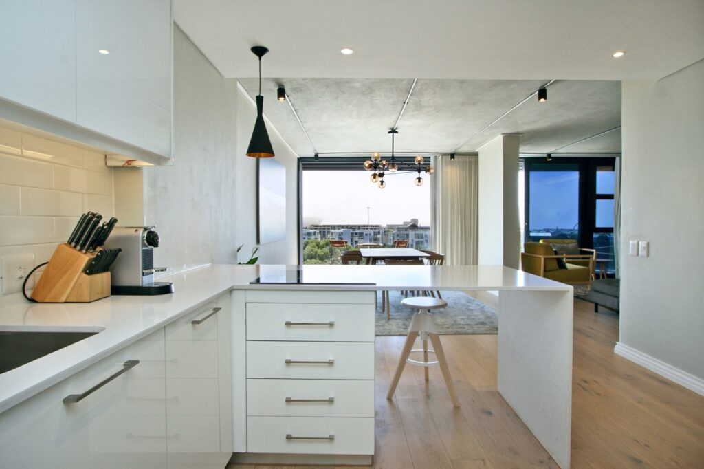 Spacious luxury penthouse kitchen and living area with modern finishes in Cape Town.